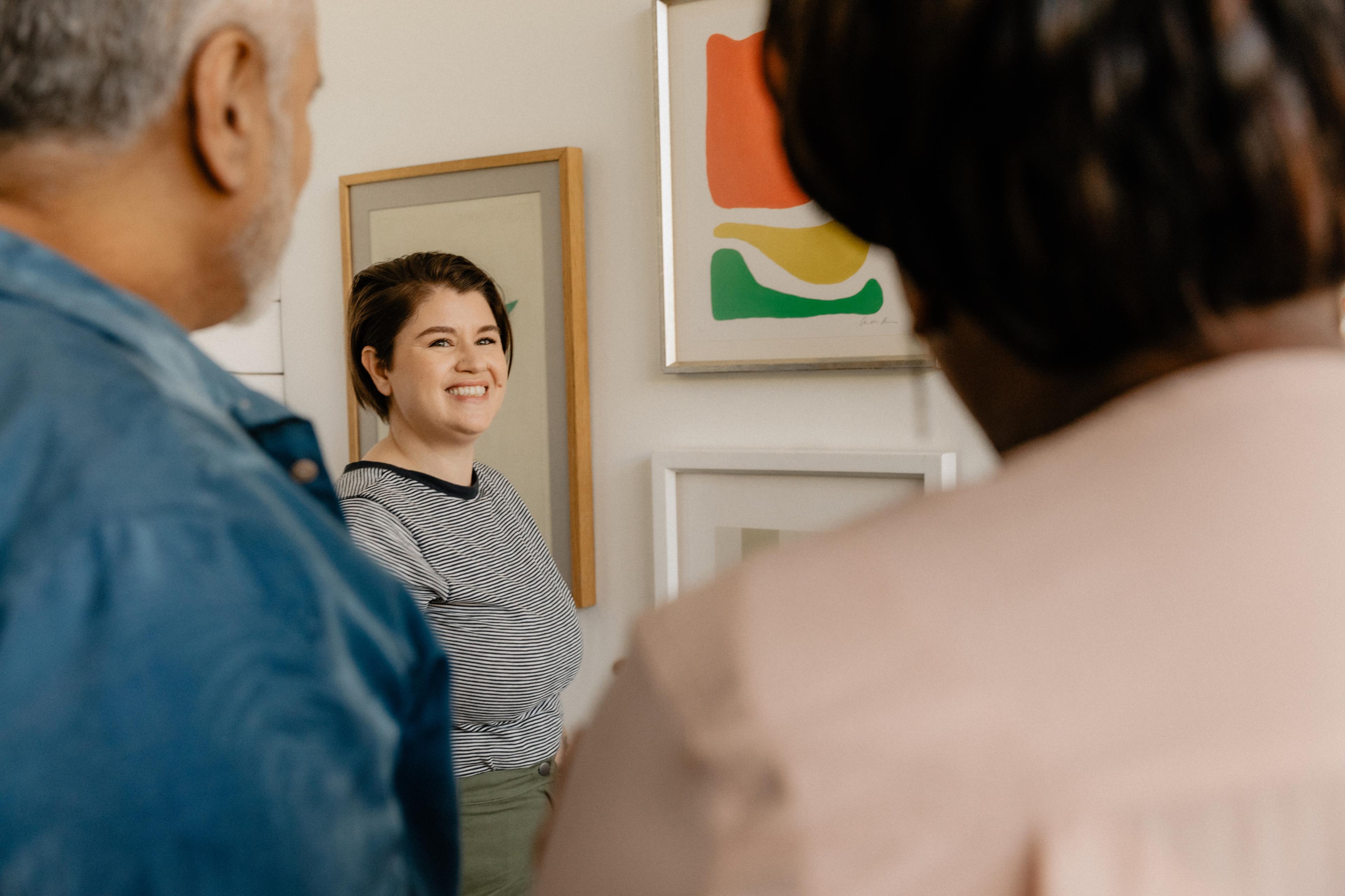 Lady smiling at a family in a room