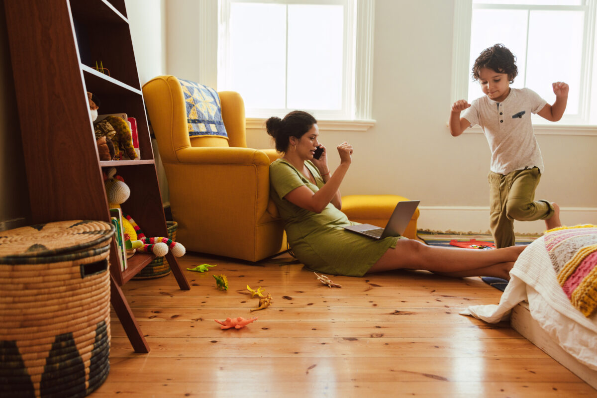 Self-employed mother speaking on the phone in her son's play area