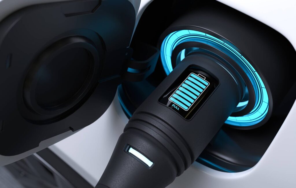 EV charger plugged into an electric vehicle showing a full battery