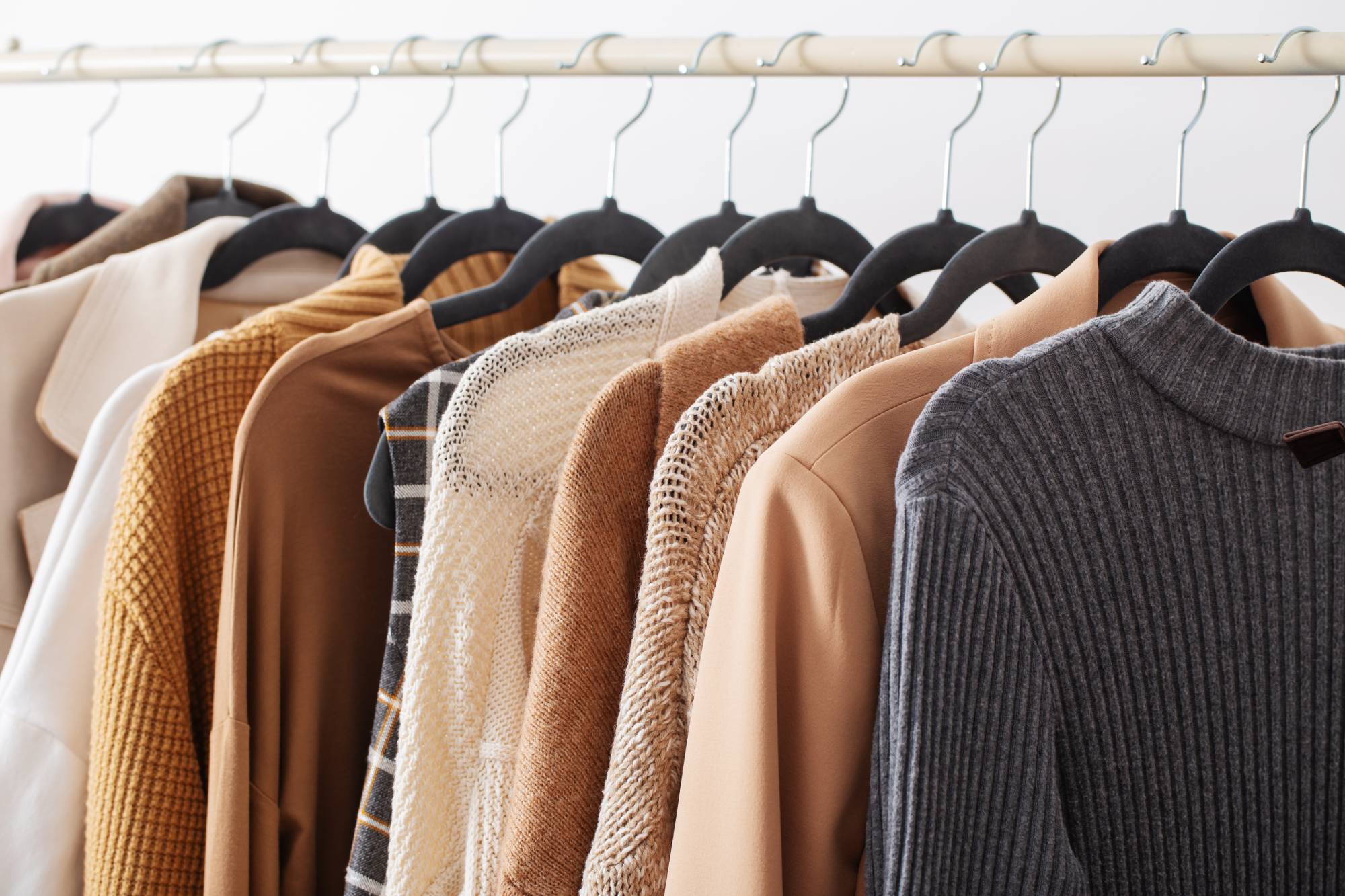 Winter sweaters hanging on a clothing rack