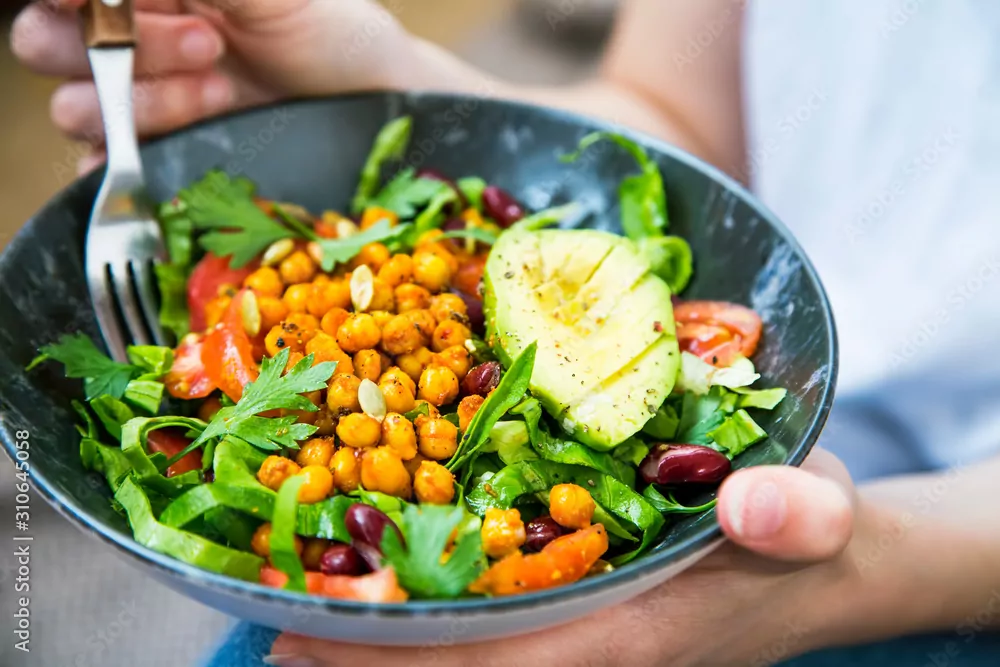 bowl filled with vegetables, beans and avocado