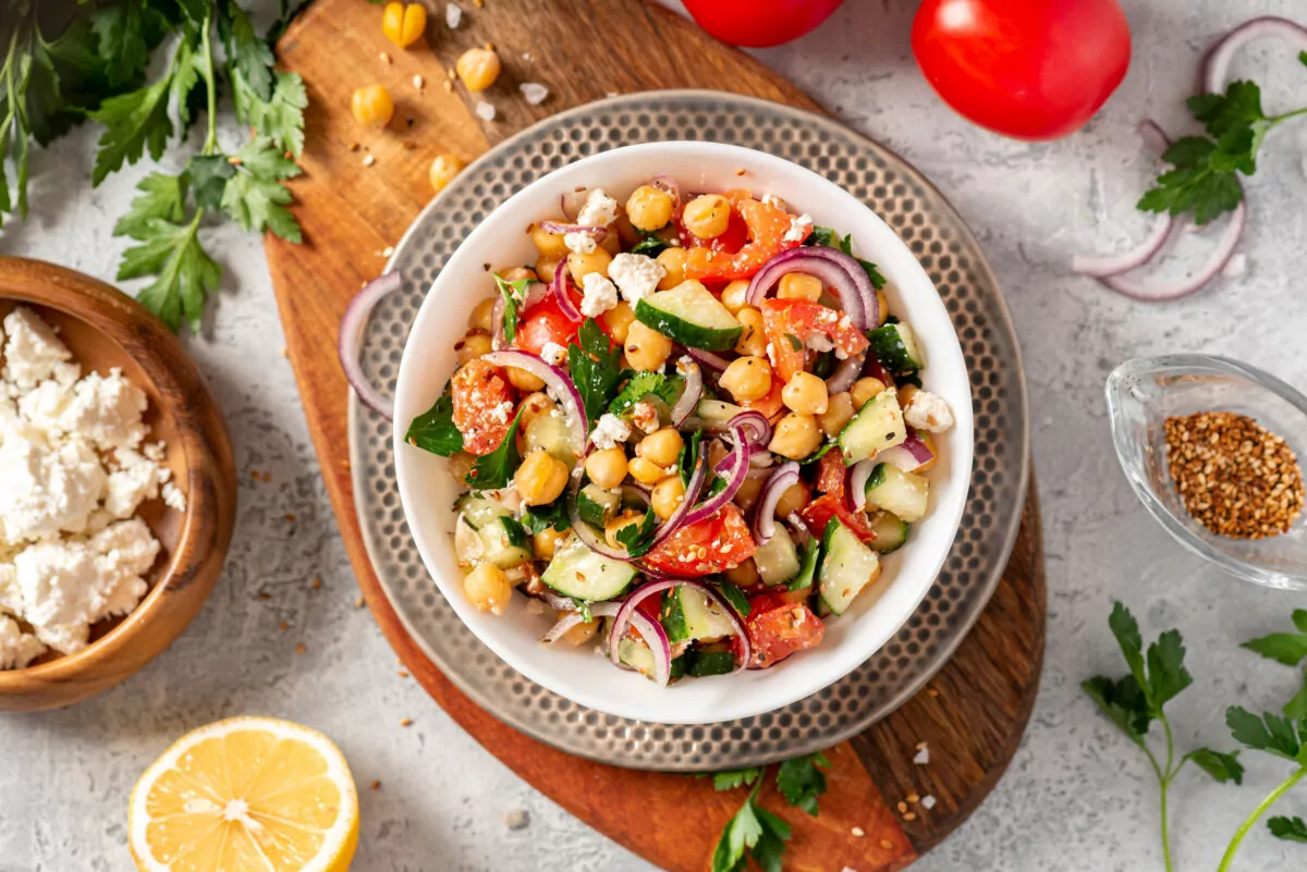 Chickpea salad with tomatoes, cucumber, feta cheese, parsley, on