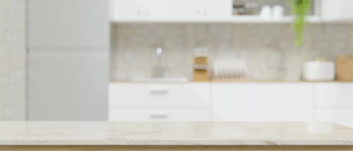 Modern marble white kitchen countertop with copy space for montage your product display over blurred apartment white kitchen interior in the background. 3d rendering, 3d illustration