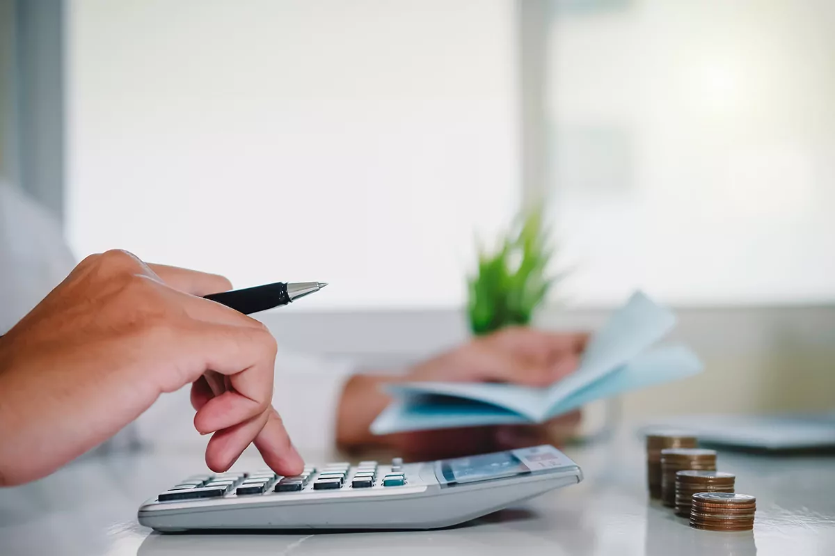 asian man working with calculator to calculate numbers