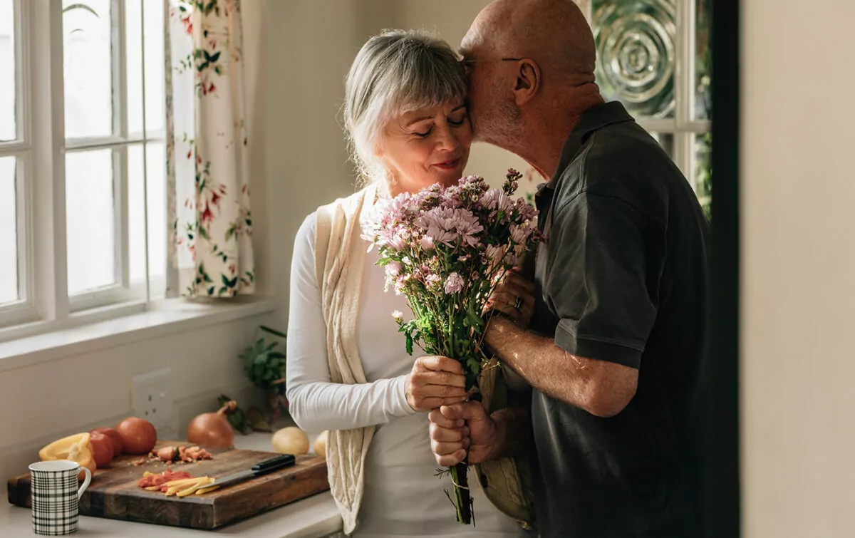 Romantic senior couple at home expressing their love